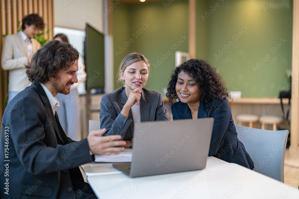 Diverse tech team meeting on software project, mentor guiding coworker ...