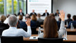 © Mselected - Audience interacts in modern conference room presentation