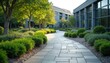 © miss irine - Paved footpath winds through landscaped commercial grounds. Modern building exterior visible. Well maintained garden includes trees shrubs, green lawn. Ideal eco friendly urban design with green