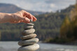 © snezhkina - Hand Balancing Stones