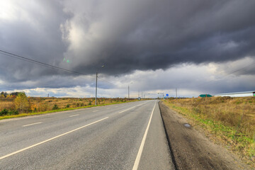 Wall Mural - Road with a lot of power lines and a cloudy sky