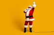 © deagreez - Santa Claus singing passionately with festive spirit against a bright yellow holiday backdrop, showcasing fun and celebration
