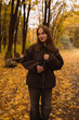 © Alex May - A beautiful young girl walks in a fairytale autumn forest with yellow leaves. An October nature walk.