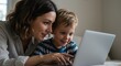 © Sandor - mother and young son bonding over educational content on laptop at home