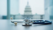 © olgakris - Stethoscope on desk with U.S. Capitol in background symbolizing American healthcare system, health policy, government reform, medical legislation, and public health debate