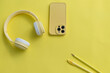 © Sabineyro - Creative monochrome flat lay with yellow headphones yellow phone yellow pencil yellow pen and yellow marker on a yellow background.