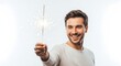 © Hamid - A smiling man holding a sparkler with a bright light and sparks against a white background.