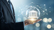 © MR360 - Man in suit holding a digital bank icon in his hand, representing modern banking, finance, and digital transformation in the financial sector