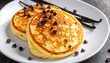 © Victoria - Delicious Chocolate Chip Pancakes on a White Plate.