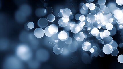 Abstract blue bokeh background with soft, glowing orbs creating a dreamy atmosphere for design use