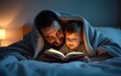 © shuai - Portrait of dad teaches his little son to read a book hiding under the blanket in bed before bedtime. High quality
