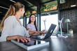 © BusinessClass by W61 - Young women testing solar panel while working at coworking space