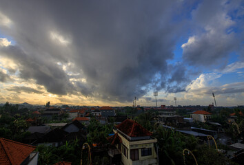 Wall Mural - Cloudy sky with a few buildings in the background