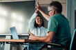© Westend61 - Doctor and patient celebrating success with high five in clinic
