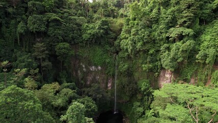 Wall Mural - Aerial View of Katibawasan Falls in Tropical Rainforest and Landscape of Camiguin Island, Philippines