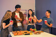 © NINENII - drinks and conversation, social gathering and get together. Young people, group and happiness at fast food pizzeria, celebration at home.