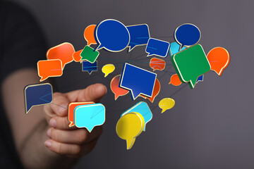 Wall Mural - Conceptual image showing a hand interacting with 3D speech bubbles, representing social media, communication, and connection.