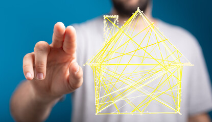 Wall Mural - Close up of a hand interacting with a 3D house model, representing real estate and digital concepts.