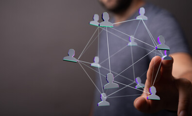Wall Mural - A person's finger interacting with a network of connected people, depicting communication and relationships in the digital world.