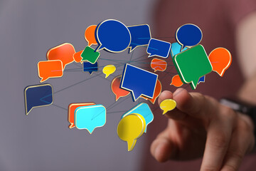 Wall Mural - Modern communication concept with hand interacting with speech bubbles for social media networks.