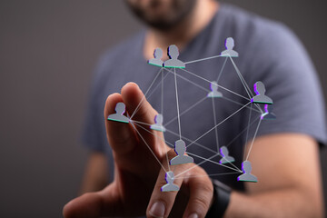 Wall Mural - Hand touches the network of digital people as symbol of teamwork, social network connection, global network and the concept of communication