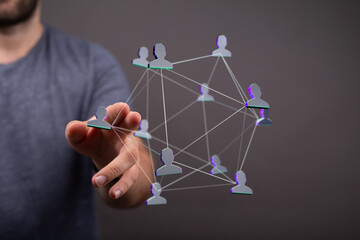 Wall Mural - Person touching connected network of people, representing community, global connection, technology and digital interaction. Concept of teamwork