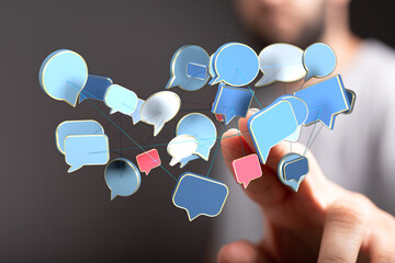 Wall Mural - A person's hand is touching message bubbles connected together. Concept of communication, social media, networking and information sharing in th