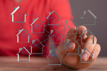 Wall Mural - Abstract concept of real estate network with houses connected by lines, hand touching and showing the idea of a digital real estate market.