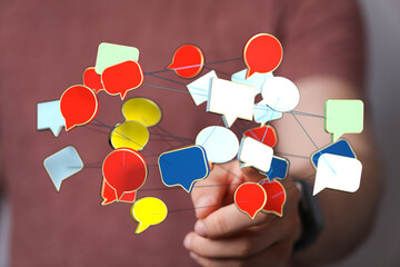 Wall Mural - Hand holding 3D rendered speech bubbles connected, communication and online social network concepts. Perfect for business marketing design.