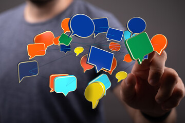 Concept of communication, social media connection. Networking and technology. Man touching chat bubbles, symbolizes digital connection, ideas an
