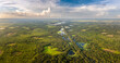 © bilanol - Florida wetlands with water between green wild vegetation. Tropical ecosystem at sunset