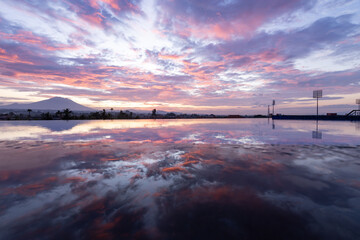 Wall Mural - Beautiful sunset over a lake with a mountain in the background
