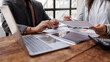 © lern seng - Business team holding pen colleagues reviewing financial data and discussing investment strategies