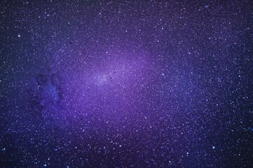 Wall Mural - An artwork featuring a violet background adorned with stars