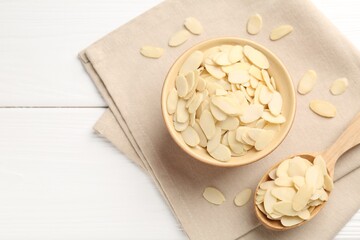 Wall Mural - Fresh almond flakes on white wooden table, flat lay. Space for text