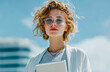 © aboutnuylove - Portrait of a beautiful young woman in sunglasses using a tablet computer on the background of the city