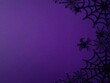 © Annbel - Black spiderweb and plastic spiders on purple background