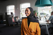 © Johnér - Happy businesswoman in hijab at office