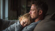 © Taras Vykhopen - Middle-aged father enjoying a quiet moment with his young child on the sofa