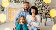 © mashimara - Christmas Family Portrait: A cheerful family gathering in a warm setting, surrounded by festive decorations and a shimmering Christmas tree, creating a scene of joy and togetherness.