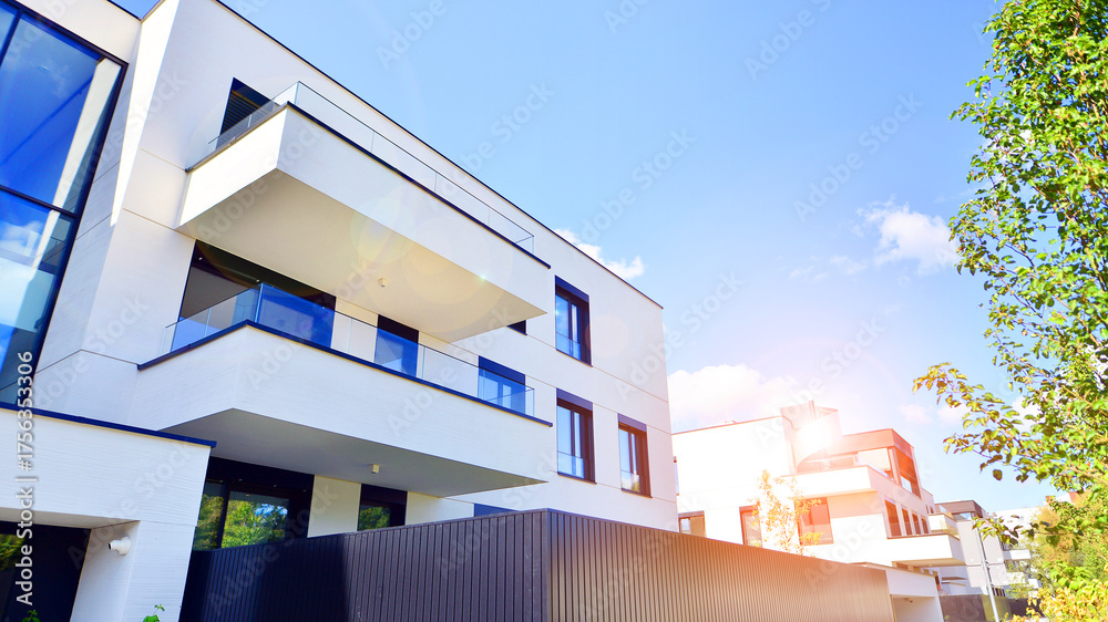 Modern apartment building with balconies and greenery. The structure ...
