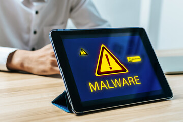 Wall Mural - Cybersecurity. digital mobile smart tablet with with virtual malware attack warning graphic icon on desk, data privacy, virus protection software, authentication, internet network technology concept