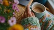 © iuricazac - Woman holding coffee cup at table surrounded by flowers.