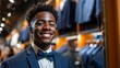 © Z A C - Man in suit smiling in store.