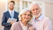 © Tonton1541 - real estate agent senior clients concept. Smiling elderly couple with a man in a suit in the background.