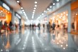 © Girl - Blurred view inside a large shopping center, showcasing a brightly lit hallway with people