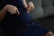 © Wiparat - Closeup of a pregnant belly, hands pregnancy