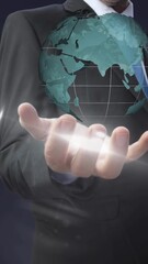 Wall Mural - Animation of globe spinning over businessman hand in background