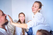 © Victoria Antre - a family plays by painting each other's faces with gold glitter during a Christmas party at home