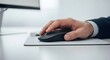 © Isa - man's hand using computer mouse on desk